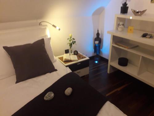 a bedroom with a black and white bed and a lamp at GÄSTEHAUS LIFESTYLE in Kirrweiler