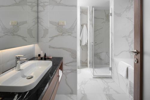 a bathroom with a sink and a shower at Hotel Milan in Pula