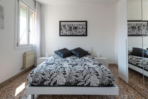 a bedroom with a bed with a black and white comforter at Cà Misericordia in Venice