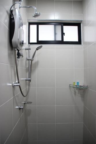 a shower in a bathroom with a window at Meridin Medini Muslim Condo in Nusajaya