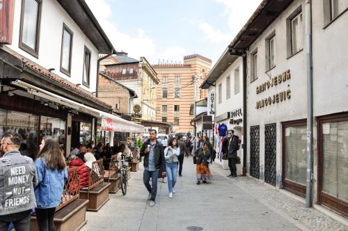 a group of people walking down a street at Apartments "Tuffo" in Sarajevo