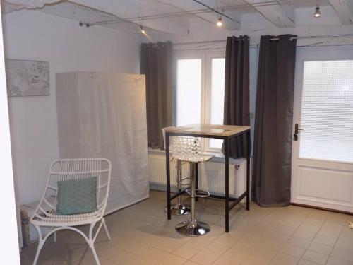 a room with two chairs and a table and a window at Charmant Studio à Colombages in Morlaix