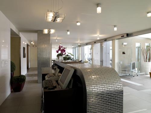 a lobby with a reception desk in a building at Hotel Montini Linate Airport in Peschiera Borromeo