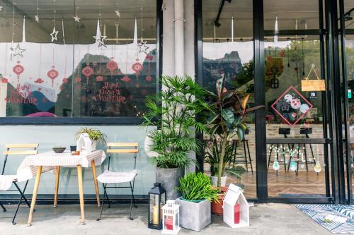 a table and chairs in front of a store at Sure I Do全景山宿 in Yangshuo