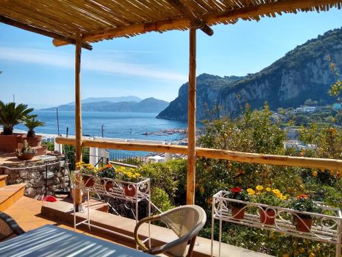 a patio with a view of the ocean and mountains at Casa Paolina - casa vacanze in Capri