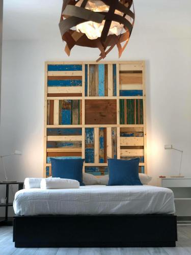 a bedroom with a large bed with a large headboard at Terra di Sicilia Luxury Centro in Avola