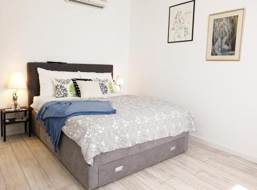 1 dormitorio con 1 cama grande en una habitación blanca en Vila Siega, en Zadar