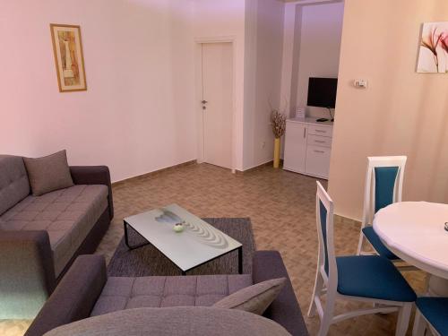 a living room with a couch and a table at Airport view Apartment in Belgrade