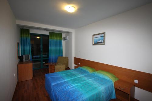 a hotel room with a bed and a window at Tanya Hotel in Sunny Beach