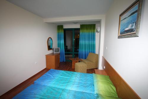 a bedroom with a bed and a living room at Tanya Hotel in Sunny Beach