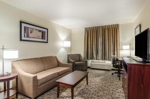 a living room with a couch and a tv in a hotel room at Cobblestone Inn & Suites - Bridgeport in Bridgeport