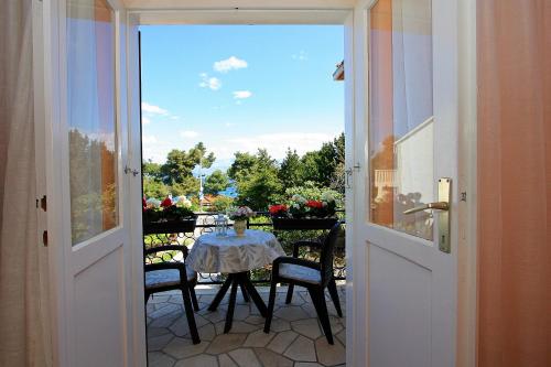 a door open to a patio with a table and chairs at 2 Bedrooms Apartment Margarita 4+2 in Supetar