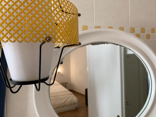 a lamp next to a mirror in a room at Room En Suite la Corte Assisi in Assisi