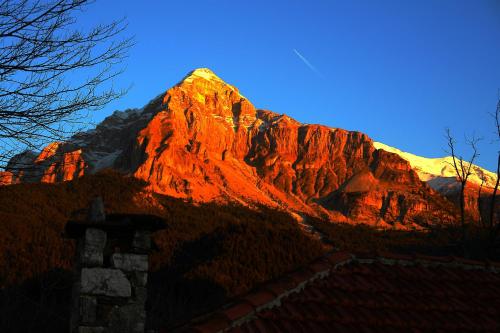 a mountain with the sun shining on it at Orizontes Tzoumerkon Hotel Resort in Pramanta