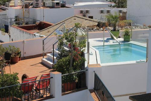 a balcony with a swimming pool on a building at Almadraba Conil in Conil de la Frontera