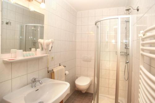 a bathroom with a sink and a toilet and a shower at Pension Linserhof in Naturno