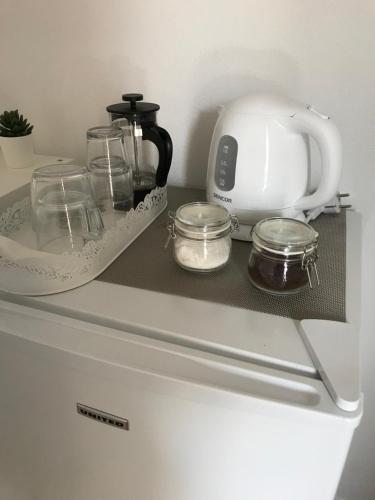 a counter with a tea kettle and glasses on it at Kamara rooms in Naousa in Naousa