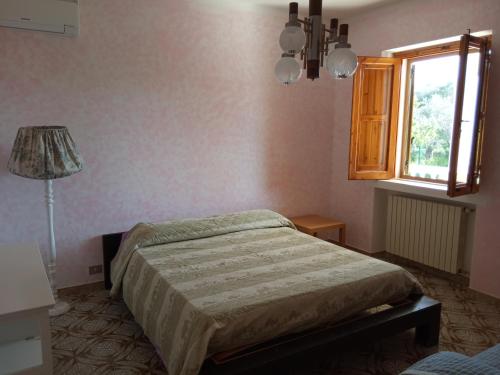 a bedroom with a bed and a window at Le dimore di Flora Charme in Monopoli