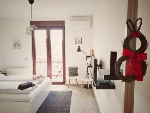 a bedroom with a bed with a red bow on it at Studio apartman Centar in Ðakovo