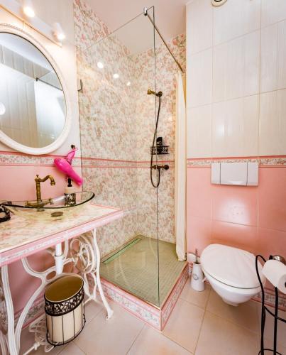 a bathroom with a shower and a toilet and a sink at Hotel Freizeittempel in Wiener Neustadt