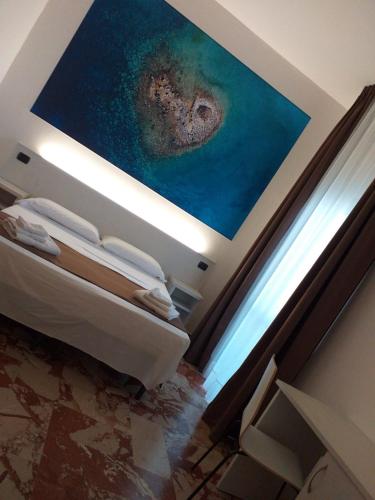 a bedroom with a painting on the ceiling at B&B L'Isola in Porto Cesareo