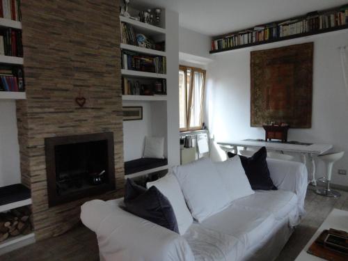 a living room with a white couch and a fireplace at Nerone's - Sutri Bed & Dinner in Sutri