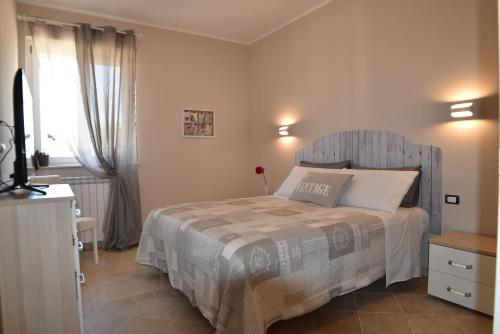 Postel nebo postele na pokoji v ubytování Appartamenti in villa Alessia