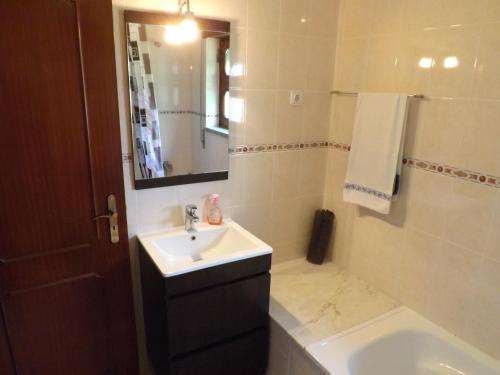 a bathroom with a sink and a mirror at Casa Oliveira in Grovelas