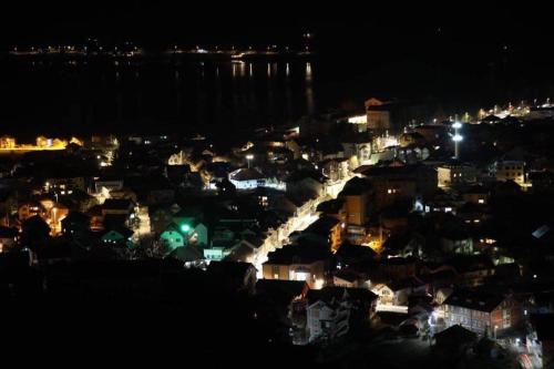a view of a city at night with lights at Apartmani Ambiente in Plav