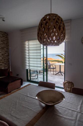 a living room with a table with a view of the ocean at AstroSunrise in Los Cancajos