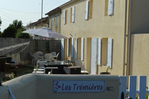 a sign on a wall in front of a building at Les Trémières in Le Thou
