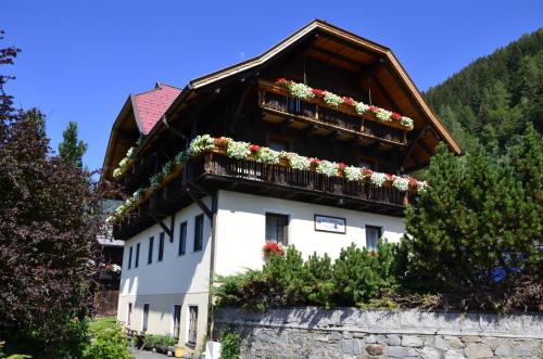 a building with flowers on the balconies on it at Panoramapension Lerchner in Bad Kleinkirchheim