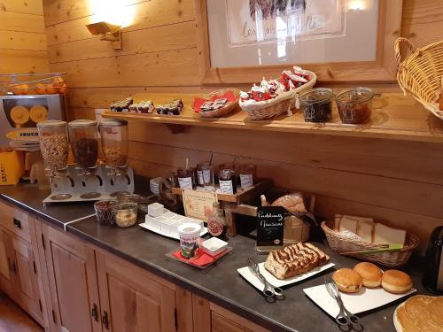 a counter top with a bunch of food on it at Alp'Hotel in La Clusaz
