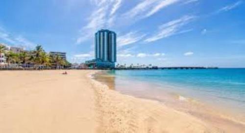 a view of a beach with a building in the background at Piso Arrecife Centro in Arrecife