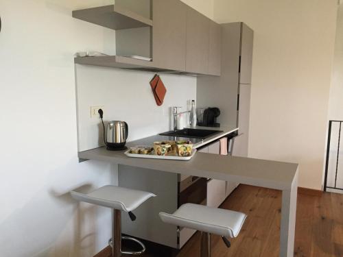 a kitchen with a table with a plate of food on it at Cascina Delle Rose in Barbaresco