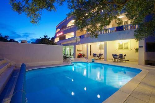 a swimming pool in front of a house at Villa Daniela in Bol