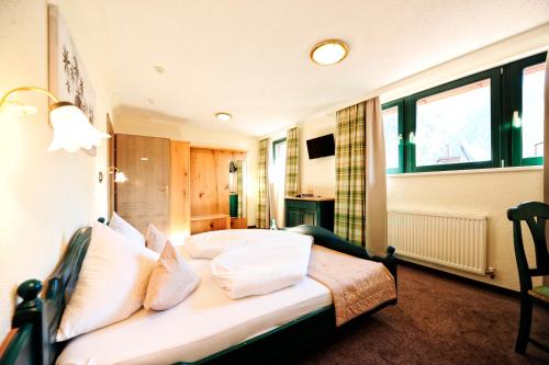 a bedroom with a bed with white pillows at Alp Resort Tiroler Adler in Sölden