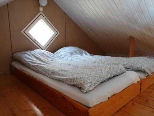a bed in a room with a window at Djurviks Gästgård in Gottby