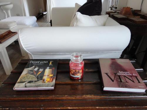 a coffee table with books and a candle on it at Nerone's - Sutri Bed & Dinner in Sutri