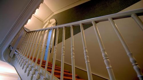 a staircase with white railings in a house at So Cool Hostel Porto in Porto