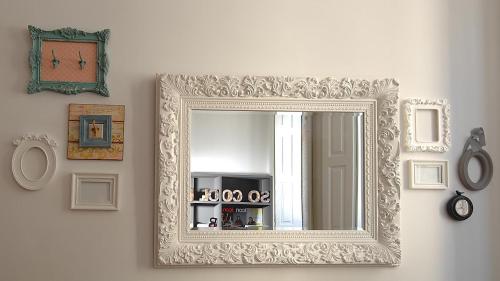 a mirror on a wall with pictures on it at So Cool Hostel Porto in Porto
