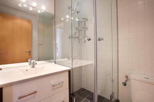 a bathroom with a shower and a sink and a toilet at Spacious apartment for families near Park Guell in Barcelona