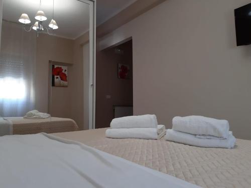 a bedroom with a bed with two towels on it at Guest Room Nesea in Pellaro