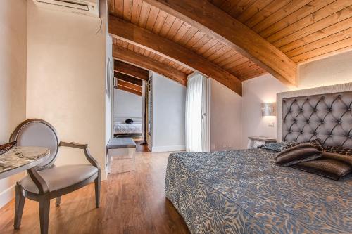 a bedroom with a bed and a table and a chair at Hotel Il Gabbiano in Cesenatico