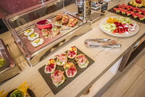 a buffet with a bunch of food on a table at Hotel Grunt in Mladá Boleslav