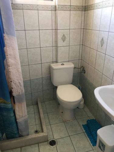 a bathroom with a toilet and a sink at Nonika’s house 1 in Tsoukalades