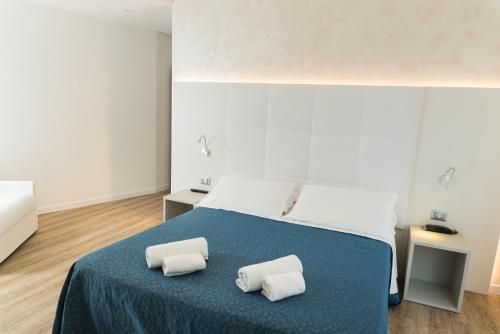 una camera con un letto con due cuscini sopra di Hotel Residence Mara a Lido di Jesolo