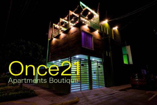 a building with a neon sign on it at night at Once21 Apartment in Guadalajara