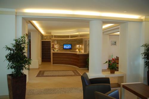 a lobby with a bar in a building at Hotel Rauscher - Das Naturteichparadies in Bad Hofgastein