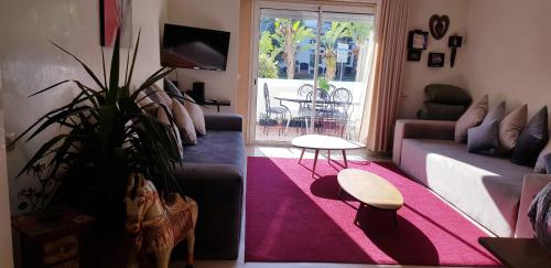 a living room with a couch and a plant at Luxury Flat Marina Agadir in Agadir